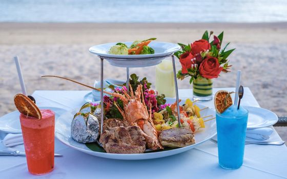dinner on the beach with lobster and cocktails