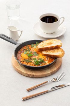 Pan of shakshuka middle eastern dish with bread
