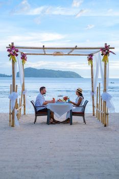 Romantic dinner on the beach in Phuket Thailand, couple man and woman having dinner on the beach 