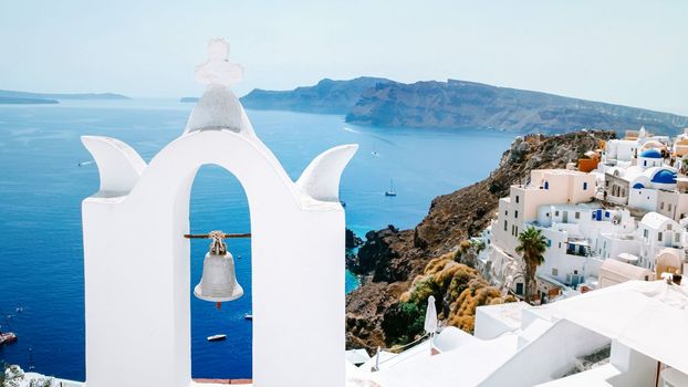 Oia Santorini with blue domes and white washed house during sunset at the Island of Santorini Greece