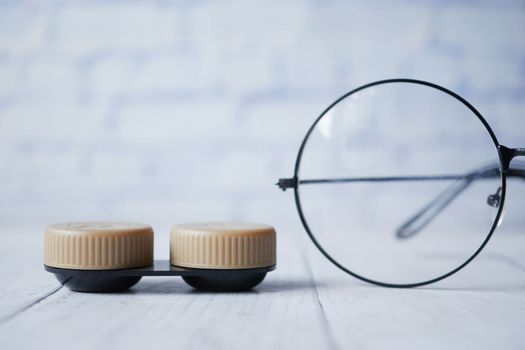close up of Contact lens and eyeglass on table 