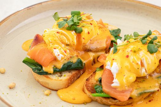 Portion of eggs benedict toast with salmon