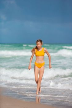 Adorable girl have fun at tropical beach during vacation