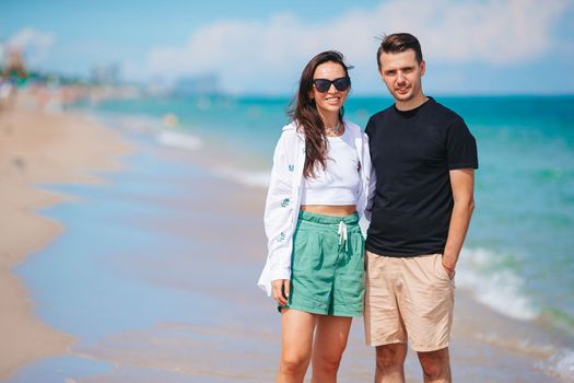 Young couple walking on the beach summer vacation.