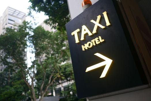 taxi stand sign on black in singapore 