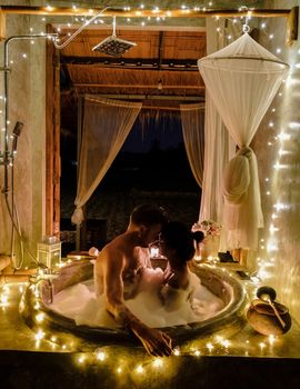 A couple of men and women in a bathtub in a homestay in Northern Thailand 