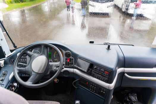 view of the dashboard and steering wheel of a tourist bus 