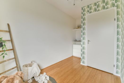A small room with wallpaper with leaves