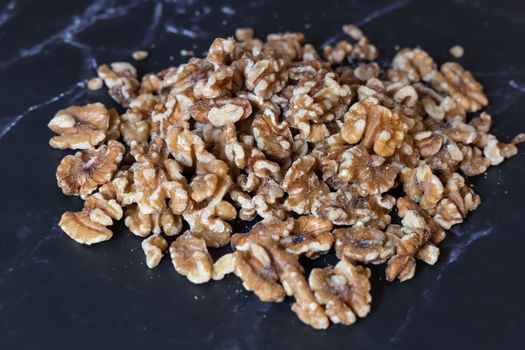 Organic walnuts kernel, nuts on a dark background.