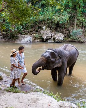 Couple visiting a Elephant sanctuary in Chiang Mai Thailand, Elephant farm in the mountains jungle