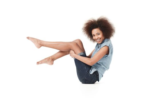 Check out my funky style. Smiling young african american woman in casual wear against a white background.