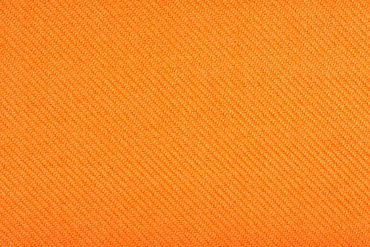 Texture of fabric for furniture upholstery. Wear-resistant fabric for furniture. Texture of orange fabric close up top view.