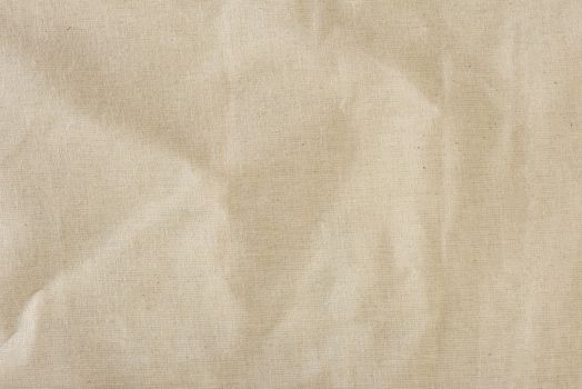 Texture of linen fabric in natural yellow color. The surface of the linen fabric as a background or banner, close-up.