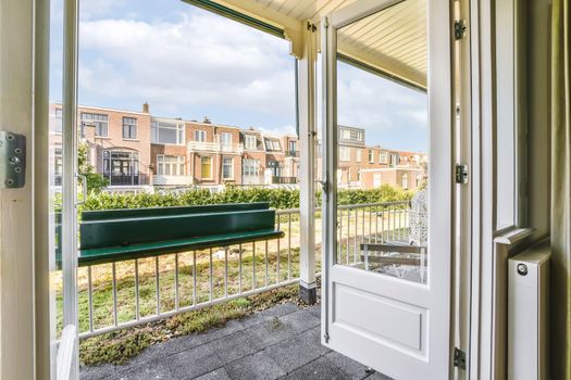 doors open to a balcony with a view of houses