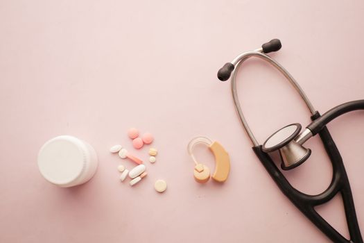 Hearing aid equipment and medical pills on table 