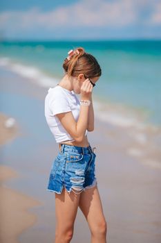 Adorable teen girl on the beach enjoy her summer vacation
