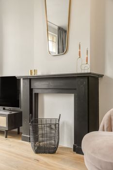 Decorative fireplace in black under the mirror