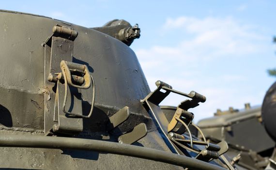 Tower of an armored personnel carrier or tank. Heavy weapons of war, sky background. Army equipment for combat and defense. Cannon tower. Details of military equipment. Close-up.