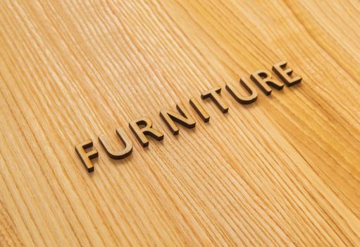 The inscription furniture on the oak table top. Background
