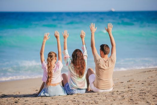Family of three on the beach having fun together