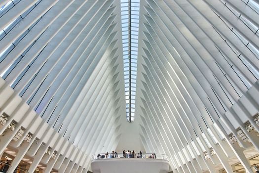 Skylights and white ribs with overlook for tourists inside clean modern subway terminal of New York City