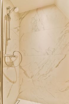 a shower with marble tiles in a bathroom
