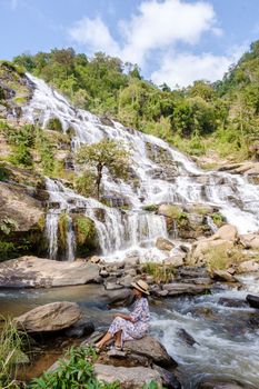 Thai Asian women visit Mae Ya Waterfall Doi Inthanon national park Thailand Chiang Mai