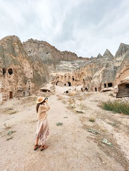 Young woman touring cave church in Cappadocia