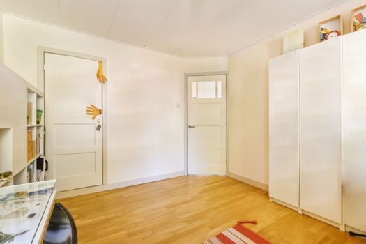 a room with white closets and a wood floor