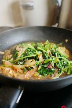 cooking spinach in a cooking pan 