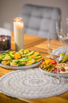 Green healthy vegan salad with arugula, avocado, shrimps and tangerines