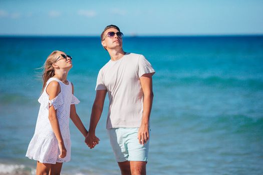 Family of dad and daughter have fun together on the beach. Family vacation