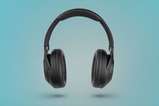 Headphones on a blue background. Wireless headphones in black, high quality, for advertising or product catalog.