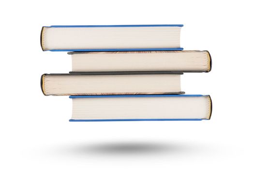 stack of books, isolate on white background. A stack of books of varying thickness falls, casting a shadow. Books are isolated on a white background, hanging in the air.