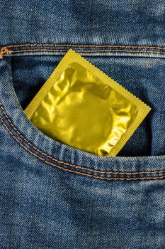 Safe sex, protection from unwanted pregnancy. Protection against sexual diseases, condoms in the pocket of blue jeans.