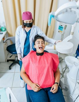 Dentist performing intraoral radiography assessment on a patient, a dentist performing dental x-rays in the office. Intraoral radiography concept, Dentist performing intraoral dental x-ray on a patient