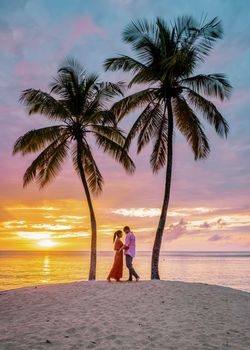 Saint Lucia Caribbean Island, couple watching sunset under a palm tree