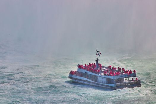 Tourist ship sailing into heavy mist at Niagara Falls