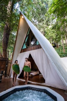 A couple of men and women staying at a luxury glamping tent in the mountains.