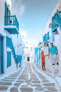 couple on vacation Mykonos Greece,Little Venice Mykonos Greece with whitewashed house at the village