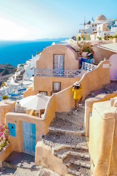 Santorini Greece, woman on luxury vacation Oia Santorini Island greece visit the white village 