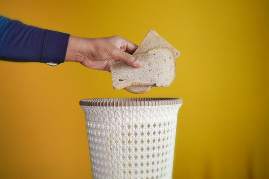 throwing breads in a garbage bin 