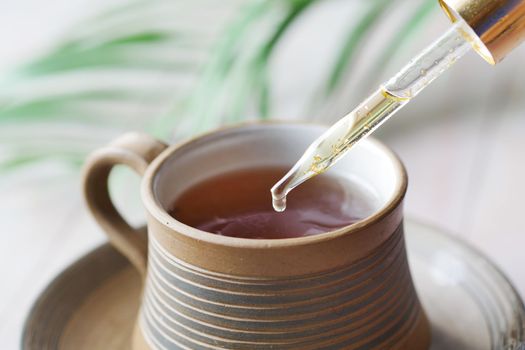 putting eucalyptus essential oils in cup of tea .