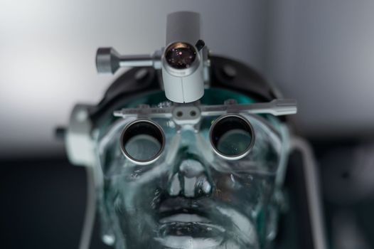 Dentist's microscope on a transparent mannequin at a medical exhibition.