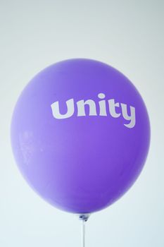unity text on a purple color ballon,