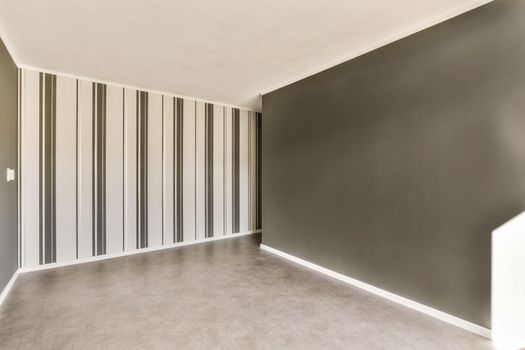 a living room with a gray wall and a carpet