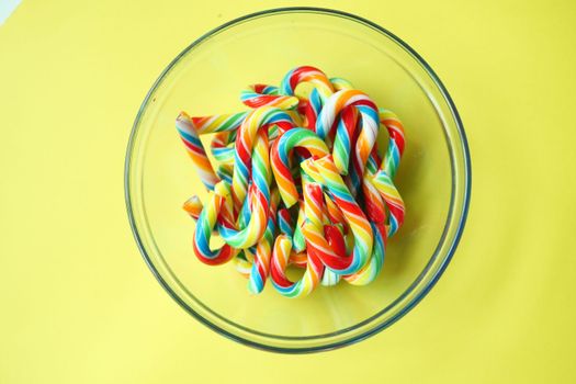 mini cherry candy canes on yellow background 