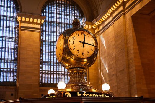 Subway clock golden light inside iconic Grand Central Station New York City