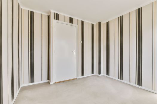 a room with striped walls and a door