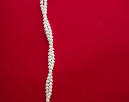 Pearl jewellery necklace on red background